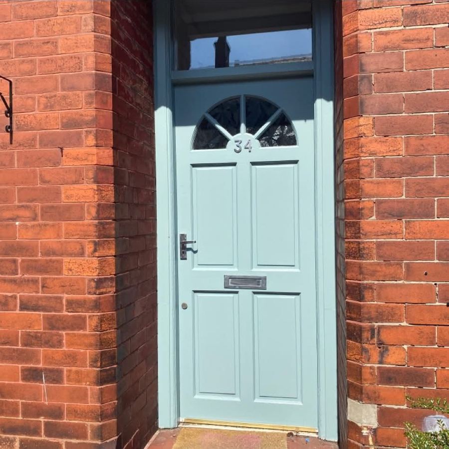 Front door repainted in duck egg blue with polished hardware