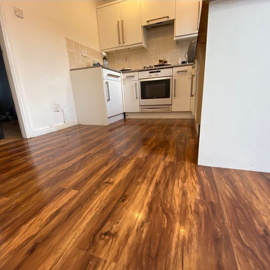 Kitchen with new warm wood-effect vinyl flooring