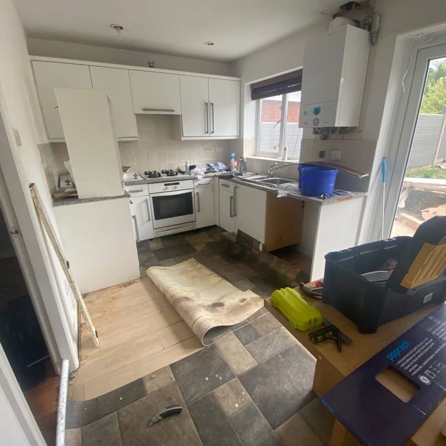 Kitchen floor mid-replacement with old tiles exposed