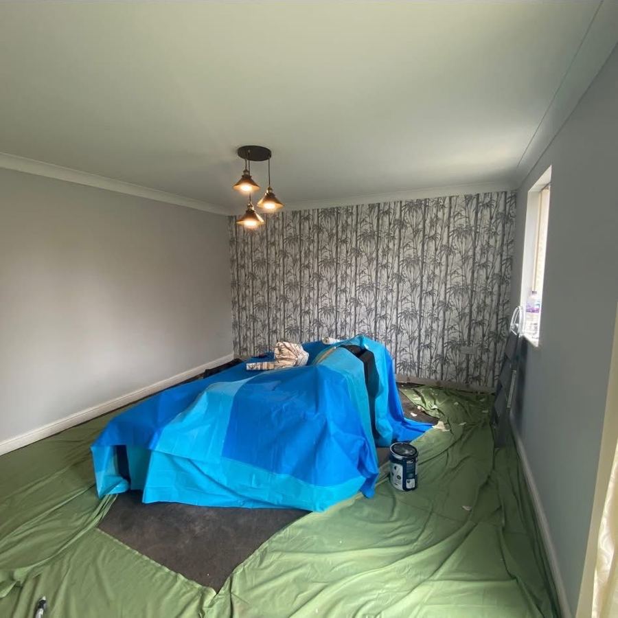 Bedroom freshly painted with bamboo-print feature wallpaper