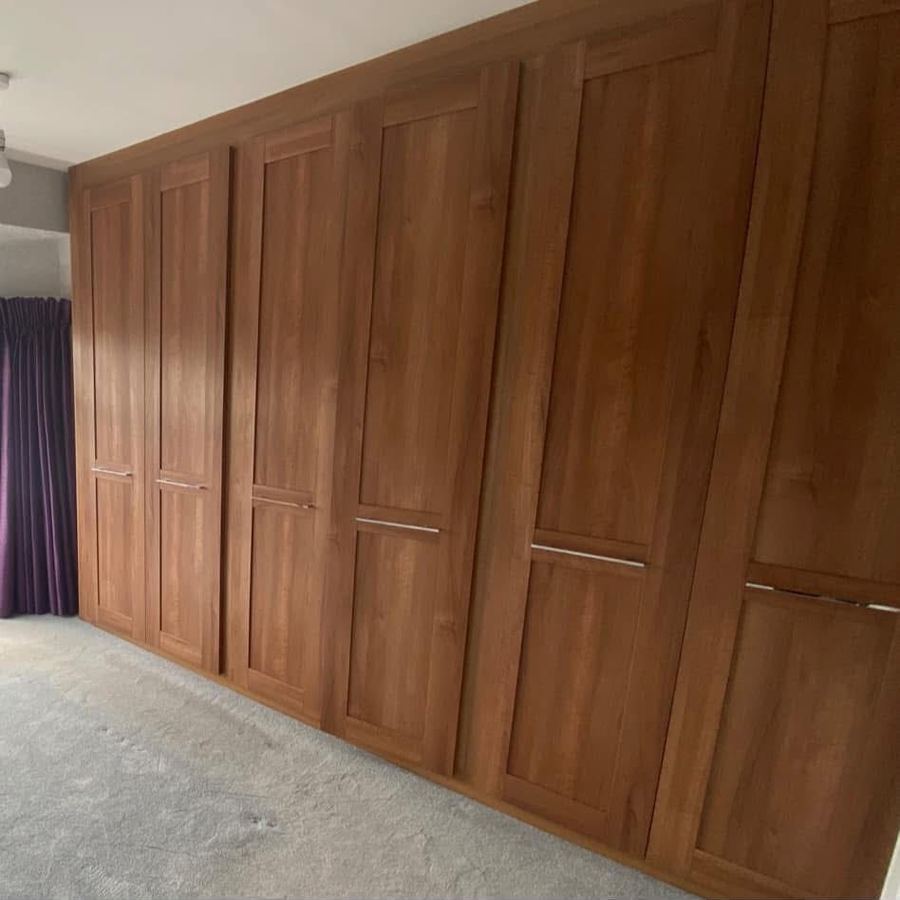 Dated brown fitted wardrobes before respray