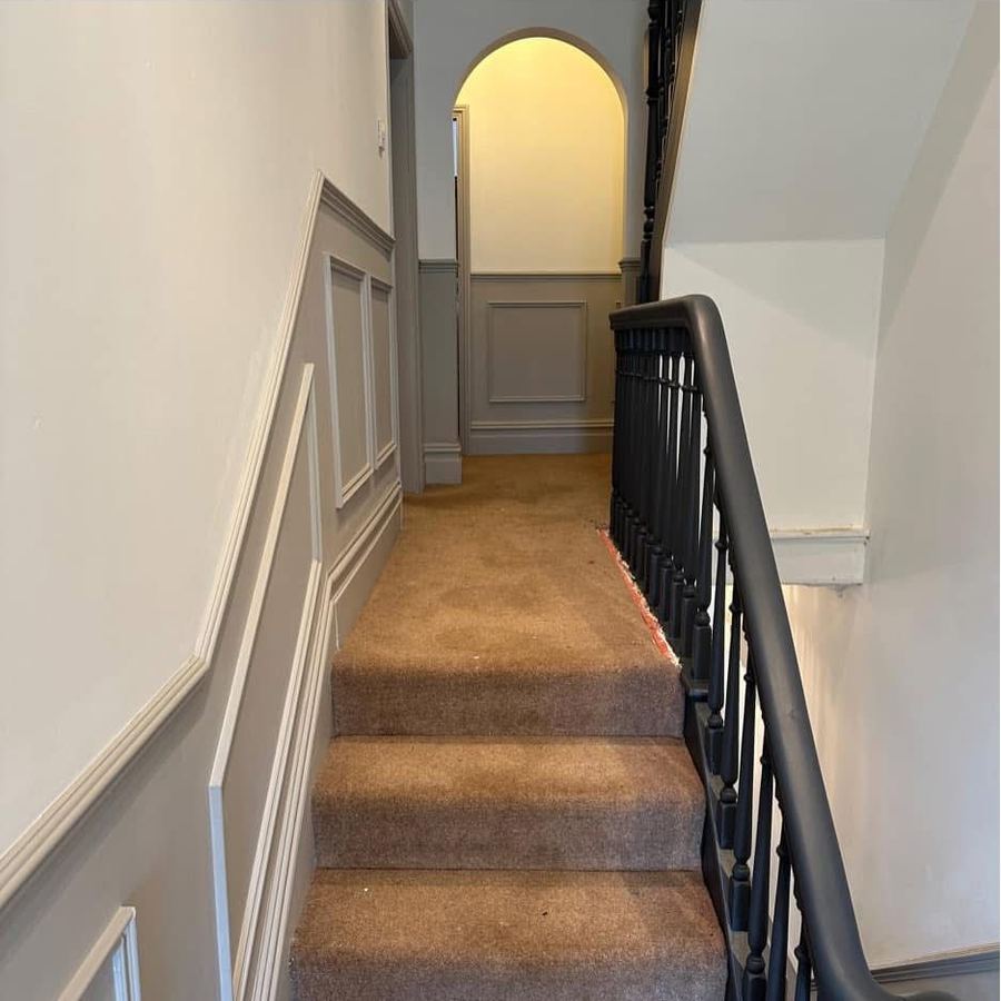 Landing with grey panelling and painted archway